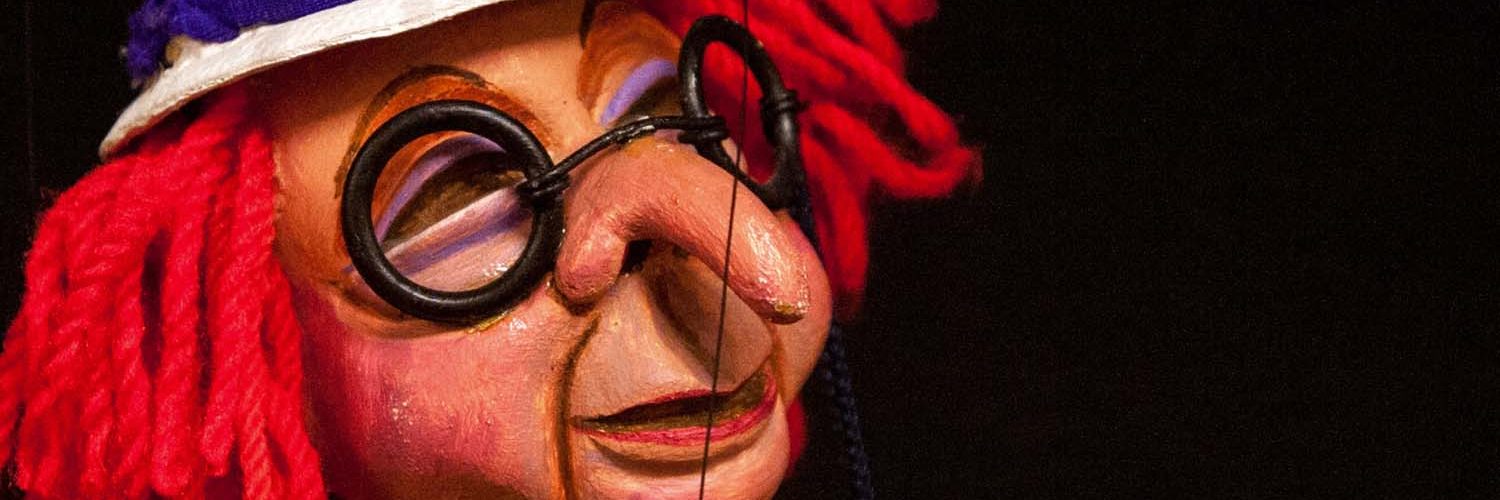 Puppet arts online classes: Puppet with long nose and red hair designed by expert puppeteer.